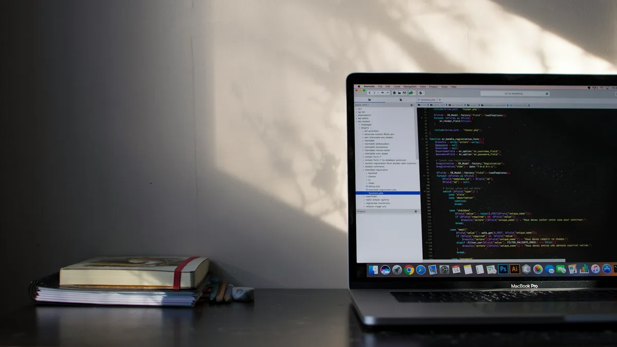 MacBook Pro showing programming code on screen